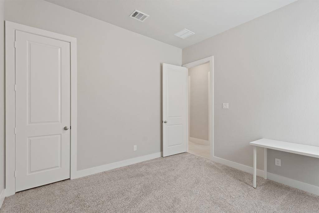 This flexible bedroom offers a generous closet and direct access to the hallway, perfect for guests, hobbies, or a private workspace.