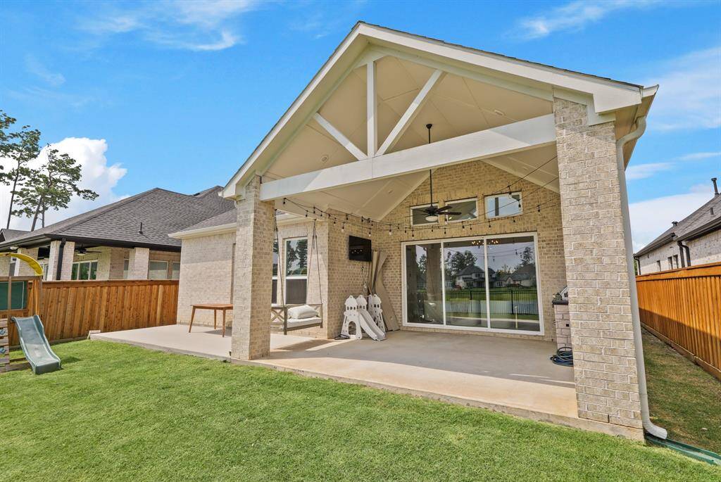 Charming EXTENDED covered patio with vaulted ceiling and swing offers year-round comfort and panoramic water views.