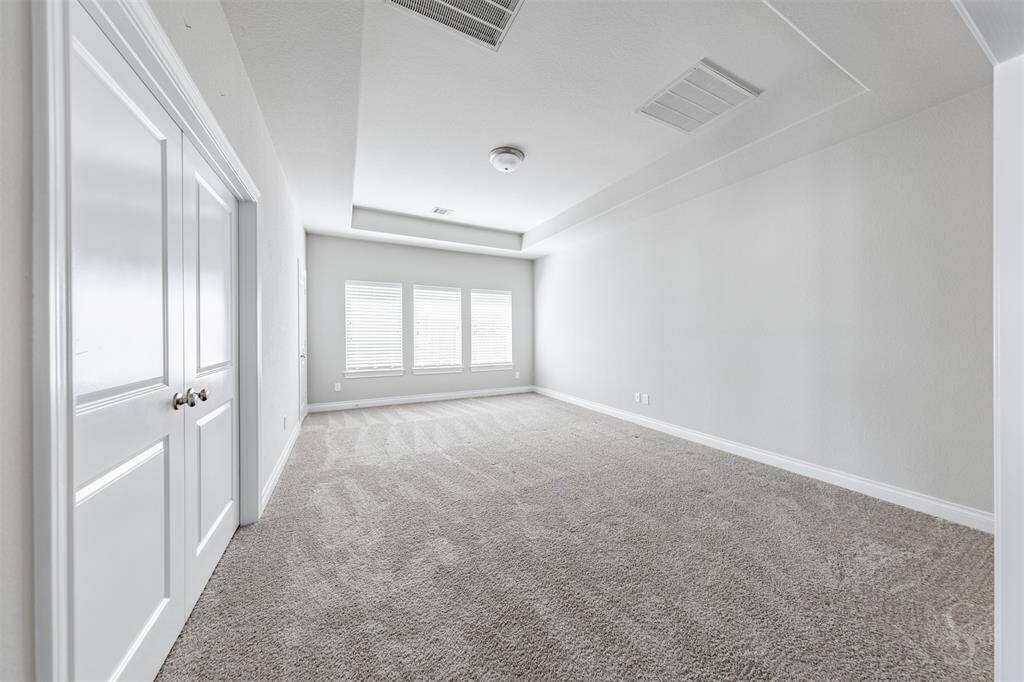 The generously sized game room is perfect for entertainment, featuring tray ceilings, large windows, and plush carpeting. Whether for billiards, movie nights, or a playroom, this versatile space adapts to your lifestyle with ease.