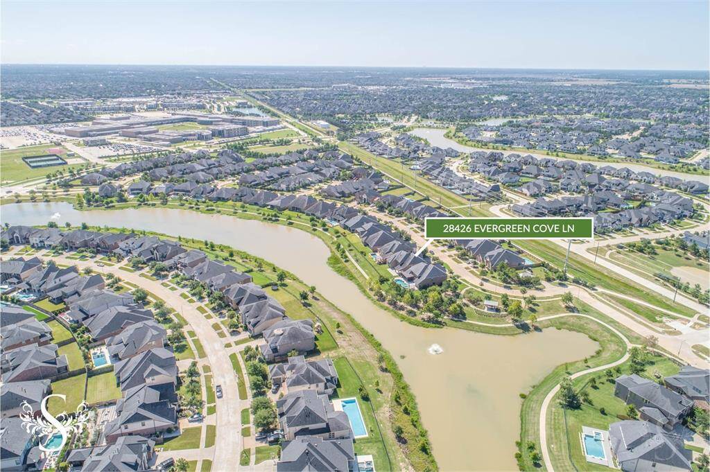 This stunning Perry Home sits on a premium waterfront lot in Cross Creek Ranch, offering serene views and luxurious outdoor living. In the background, you’ll spot Adams Junior High and top-rated Jordan High School—both part of highly acclaimed Katy ISD.
