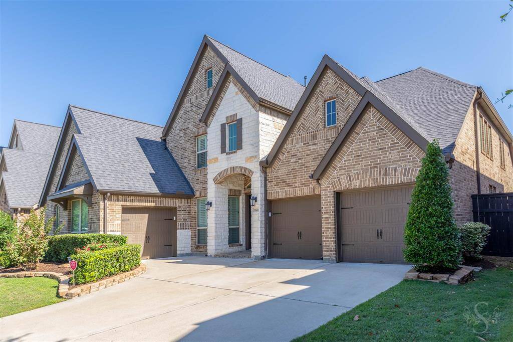 Grand curb appeal welcomes you to this stunning Perry Home, with a striking brick and stone elevation, professional landscaping, and a 3-car split garage.