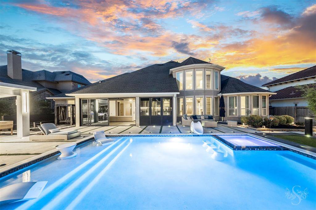 A wall of windows and architectural angles frame the home’s resort-caliber backyard, where twilight reflections dance across the pool and spa. This is luxury outdoor living at its finest, with seamless indoor-outdoor flow designed for both relaxation and celebration.