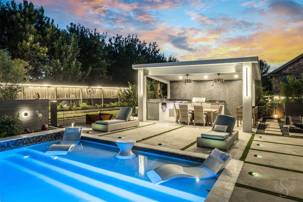 Host unforgettable nights in this custom-designed outdoor pavilion, complete with built-in grill, prep space, and a generous dining area. Lounge poolside with friends and savor the glow of sophisticated lighting that transforms the backyard into a private resort after dark.