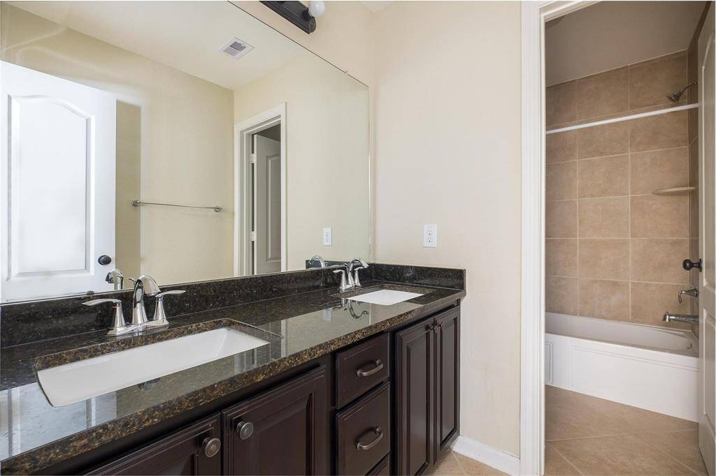 Bathroom up stairs with 2 sinks and a shower bath combo