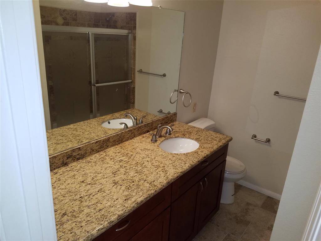 Private bath in the second bedroom. Note the granite and the tile floor.