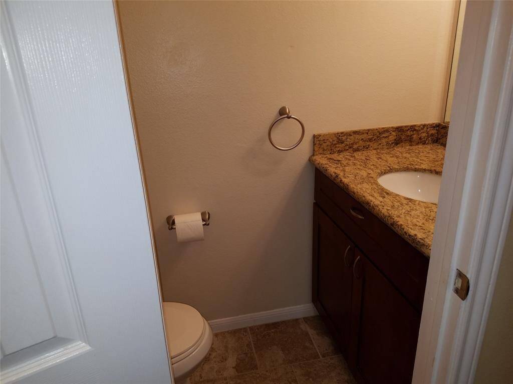 Downstairs guest bath with granite and tile.