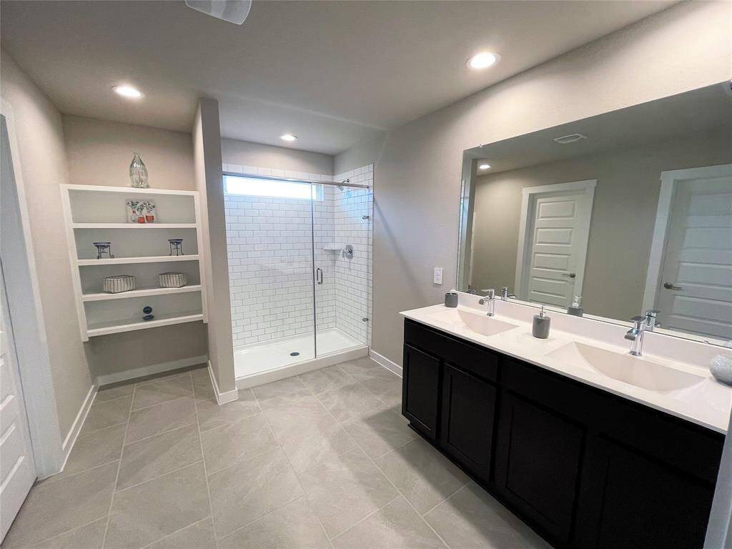 Double vanities and linen closet in main bathroom.