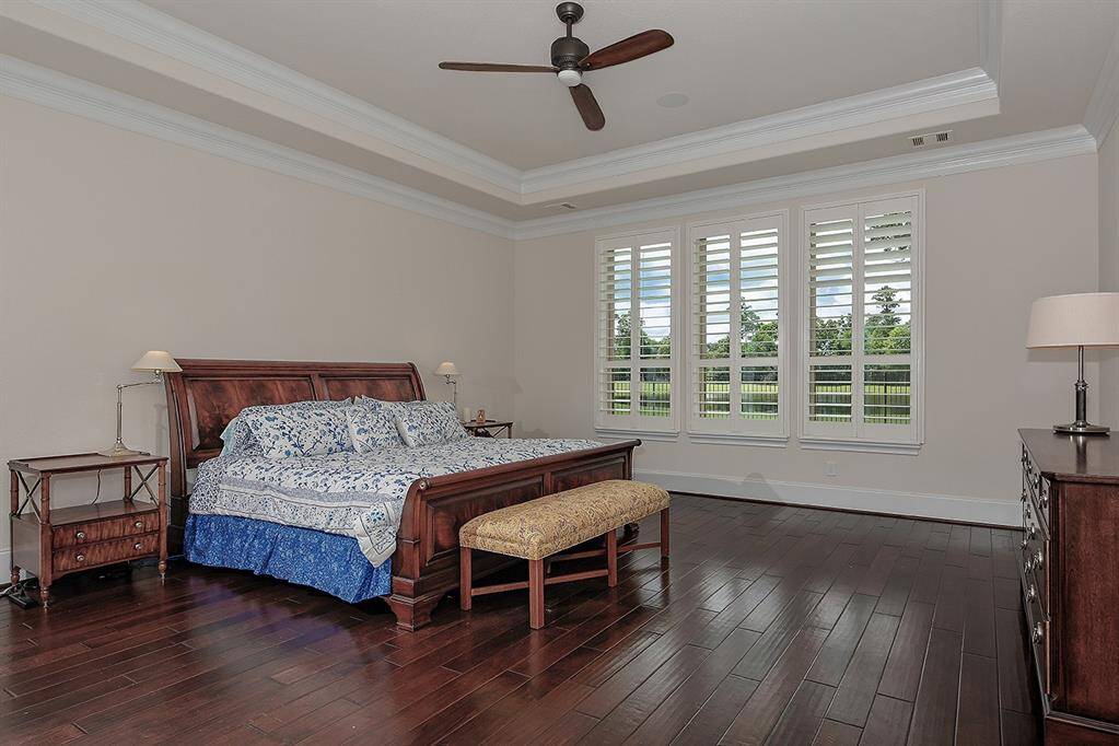 Main floor, luxurious primary retreat overlooking the golf course and pool