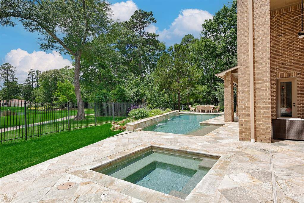 Relax in the backyard oasis while enjoying a soak in the spa or floating around the pool