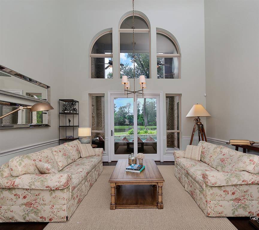 Breathtaking views of the golf course, pool and water in the 2 story living/dining room