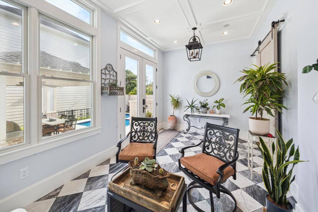 View of the porch off the family room with access to the turfed backyard.