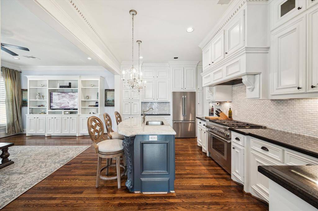 The living room features cased openings to the kitchen and dining room, along with direct access to the front porch, making entertaining effortless.
