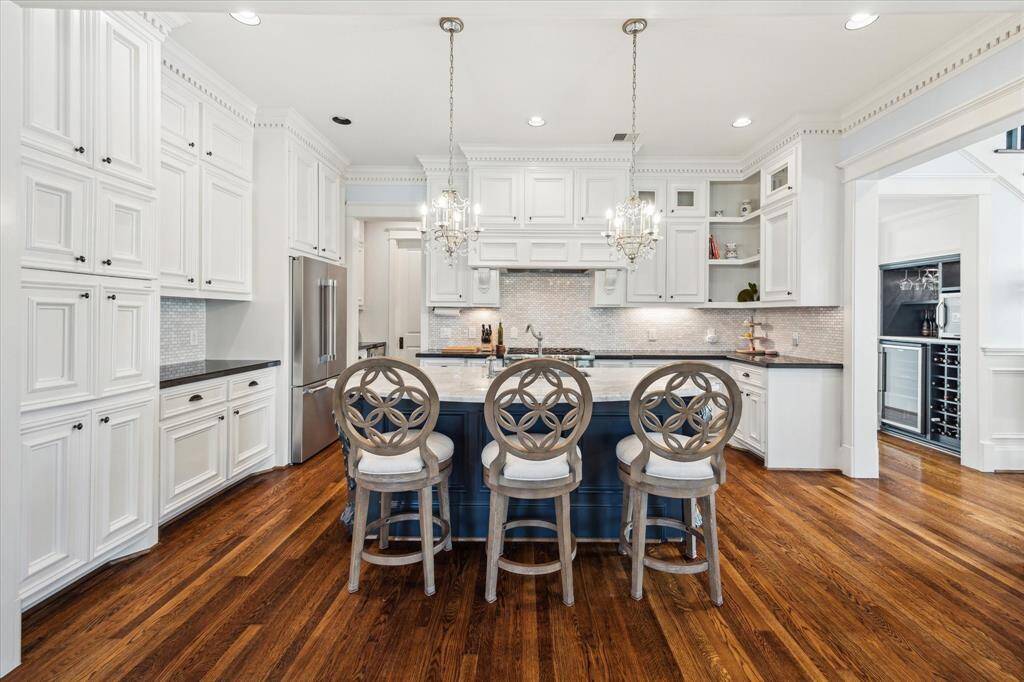 This view showcases the gorgeous hardwood floors and the stunning millwork featured throughout the home.
