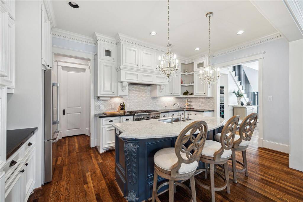 Stunning kitchen equipped with a high end Thermador 6-burner gas range with convection and gas oven, along with a matching Thermador refrigerator and dishwasher, all installed in 2024 for modern convenience and elegance.
