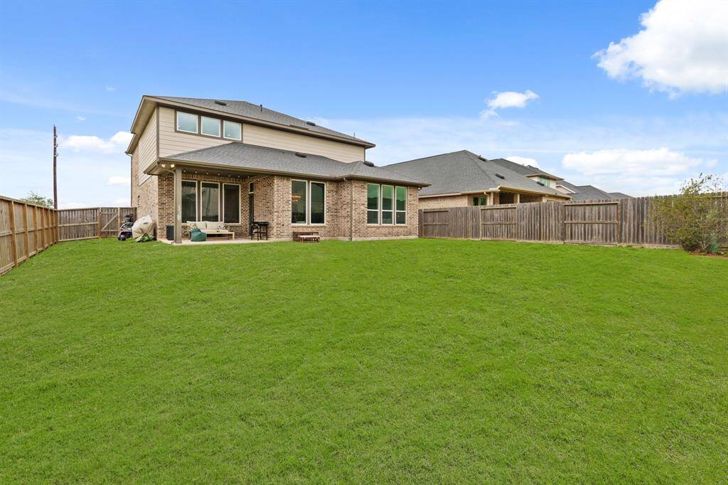 Generously sized fenced backyard offering privacy, play space, and endless potential for outdoor living.