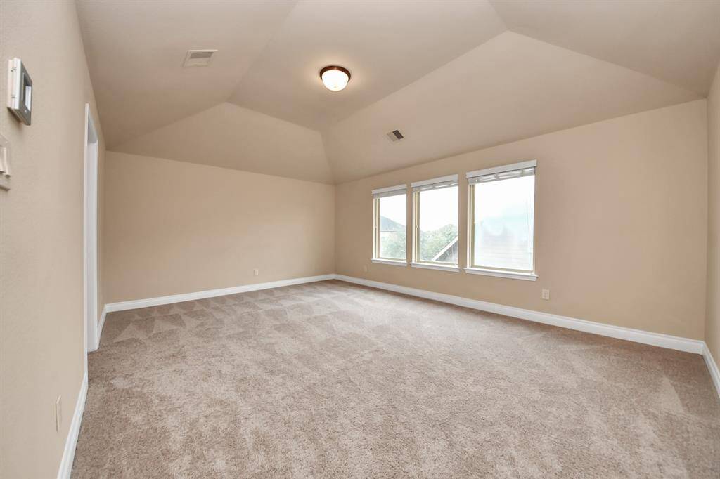 A large media/game room with a half bath is ideal for movie nights and fun activities
