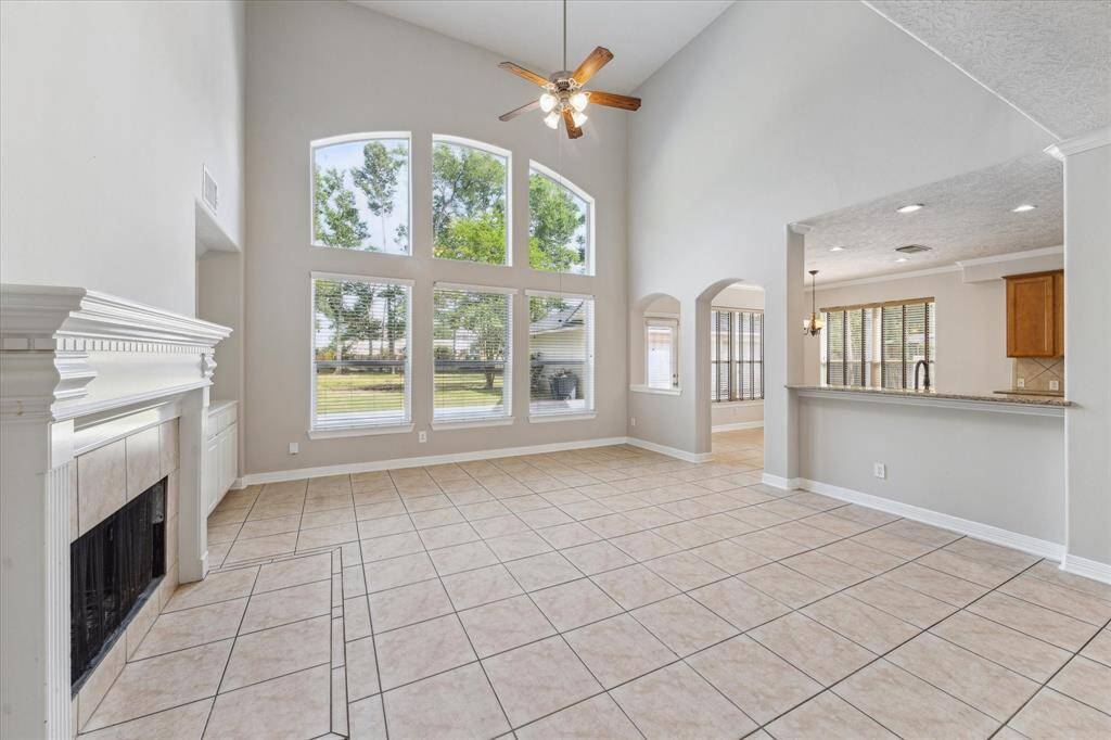 Family room features ample natural light, built in cabinetry and soaring ceilings.