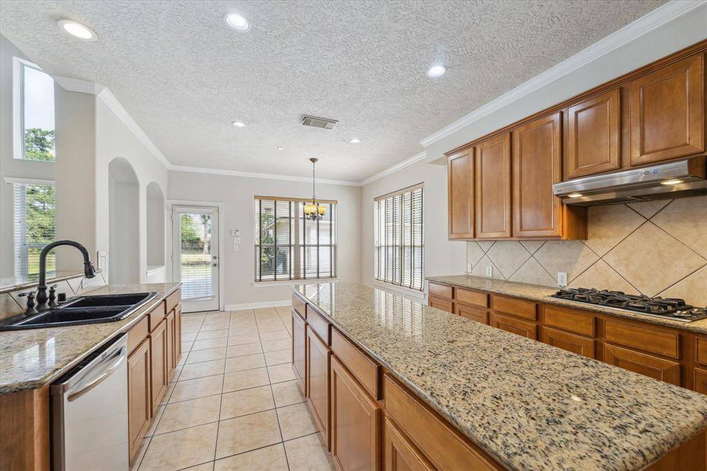 Spacious and sunlit kitchen with large, inviting island.
