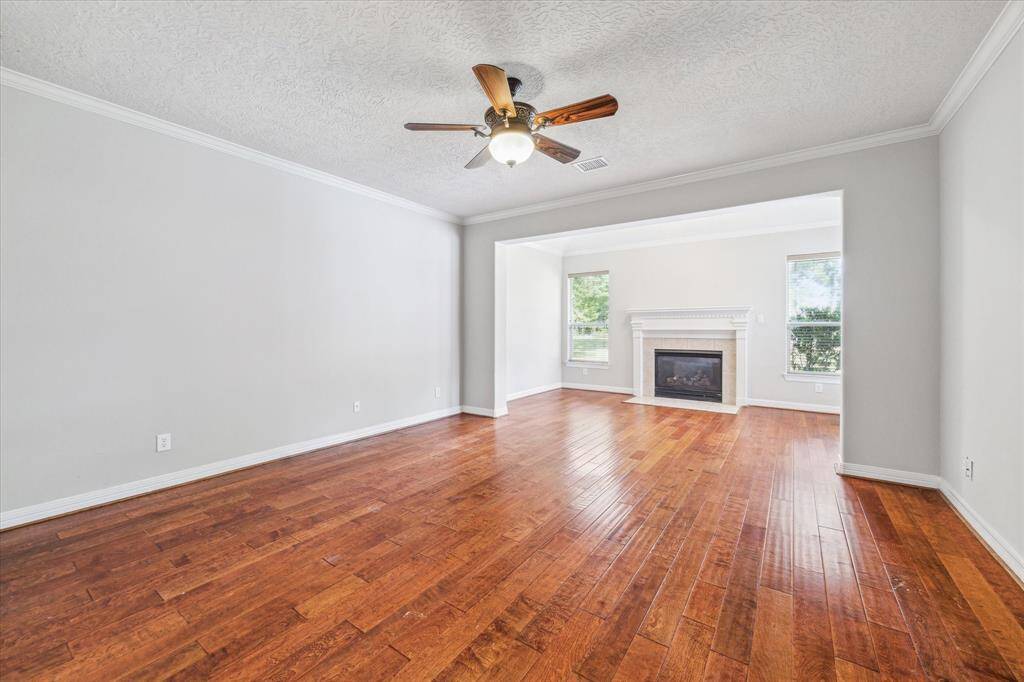 The primary bedroom also offers a sitting room with gaslog fireplace overlooking the backyard.