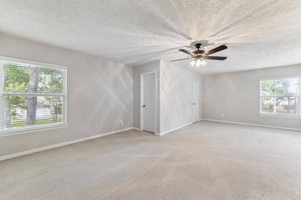 Look at this bright, spacious upper level bedroom featuring two walk-in closets.