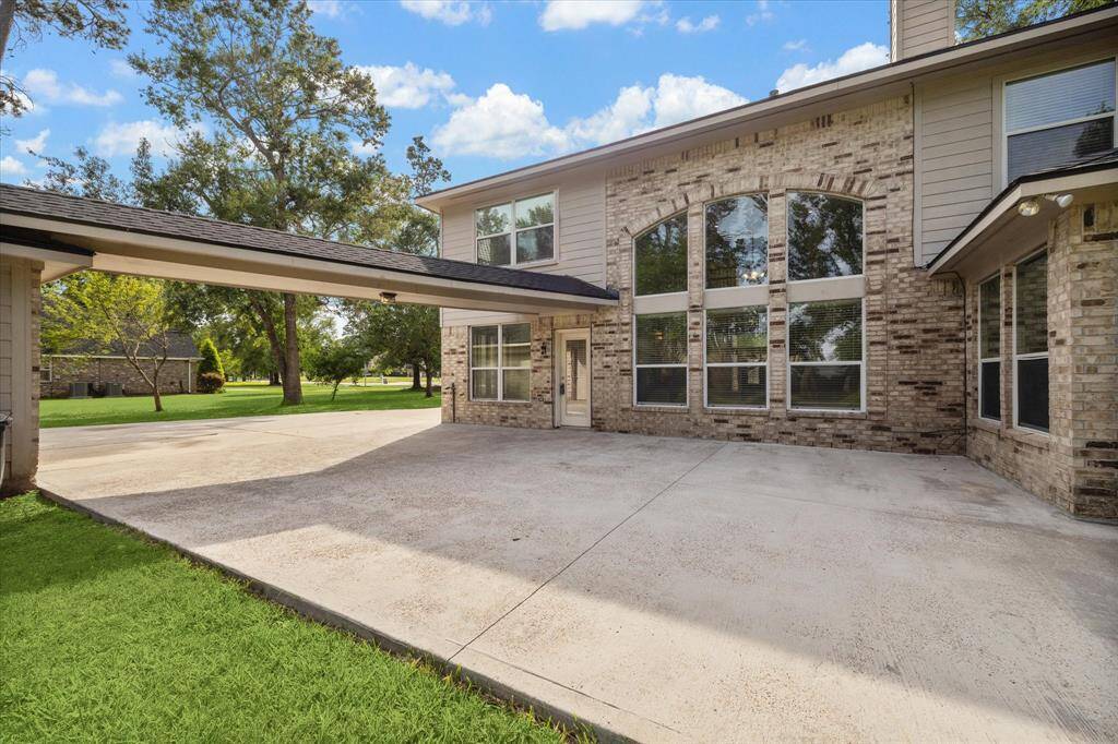 View of the back of the home and covered walk way leading to the garage.