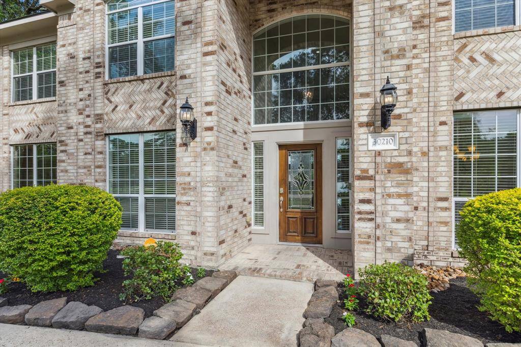 The well maintained lawn and landscaping leads you to a gorgeous solid wood door.
