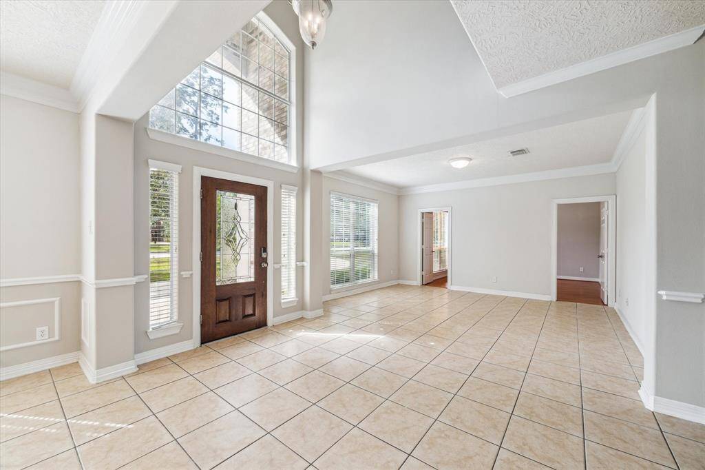 Entry of the home is flooded with ample natural light, tall ceilings and fresh paint.