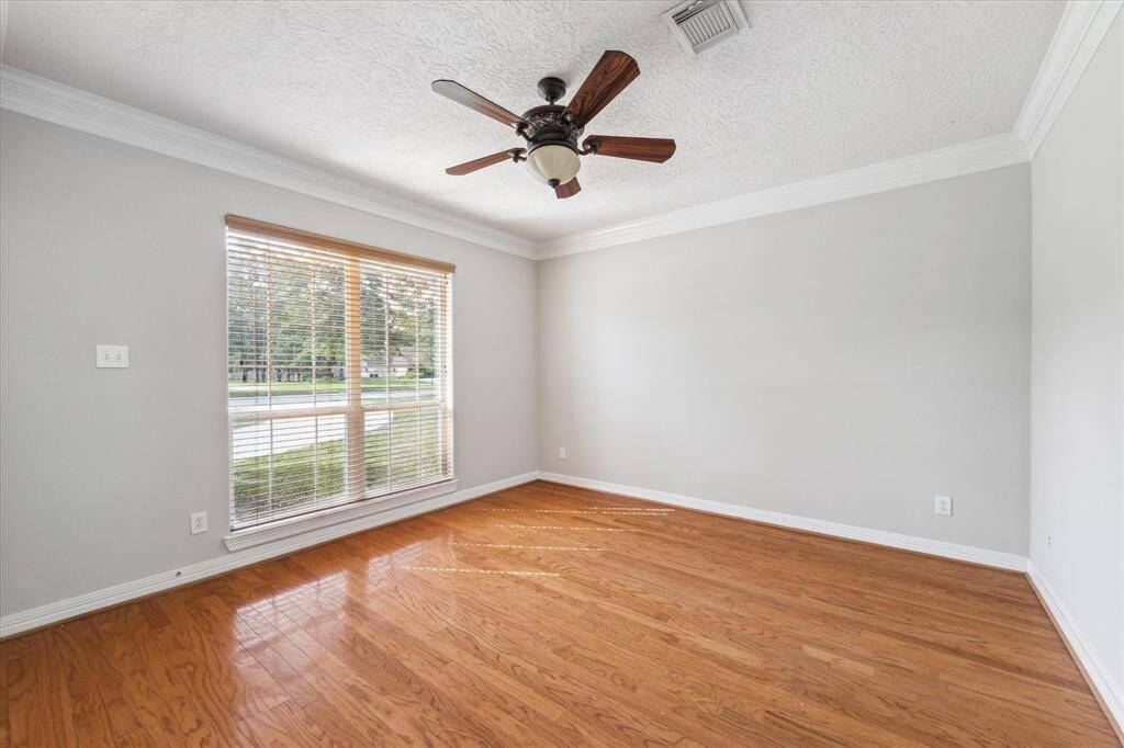 Just off the formal living room is the home office or additional bedroom with hardwood flooring.