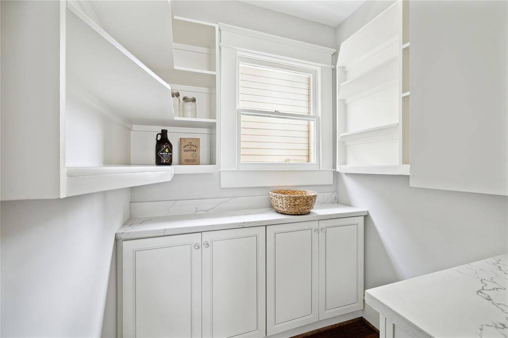 The quaint walk-in pantry just off the kitchen has plenty of storage.  Counterspace can be used for a coffee station, appliances or food storage/prep.