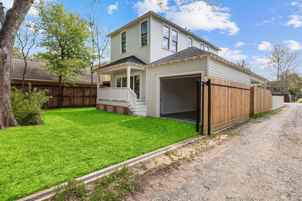 DUAL ACCESS: Auto driveway gate AND also alley access at the rear! (Gate shown open in this photo).