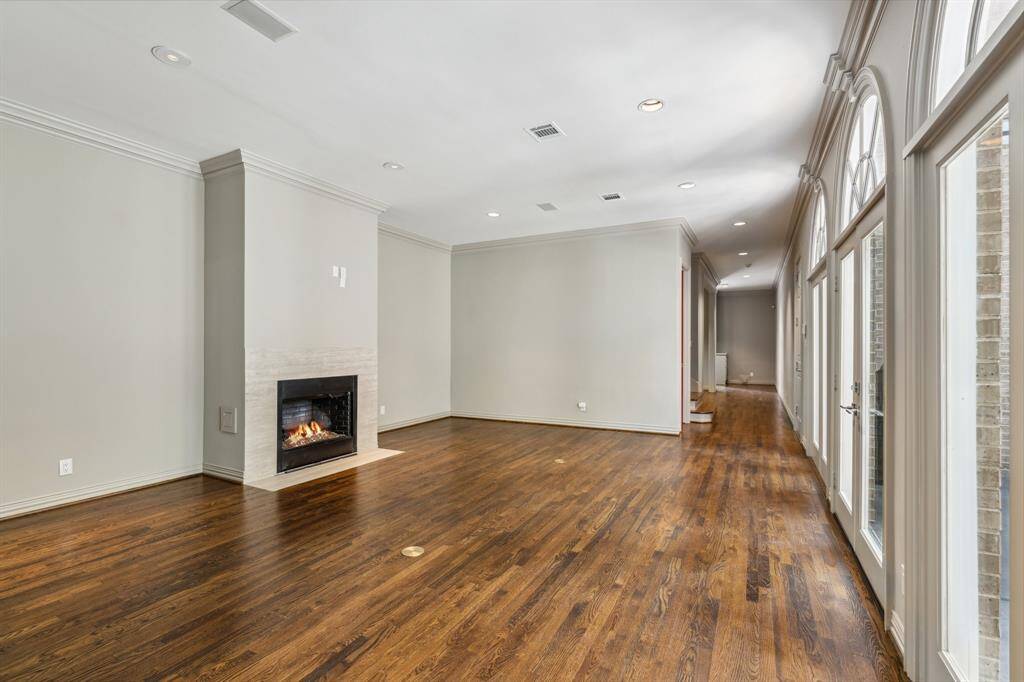 A view of the Family Room up the Gallery past the staircase, the Powder Bath and the Living Room (all out of view to the left of the Gallery).  The 3-sets of double French doors allow the natural light to bathe the entire interior of this home with sunlight.