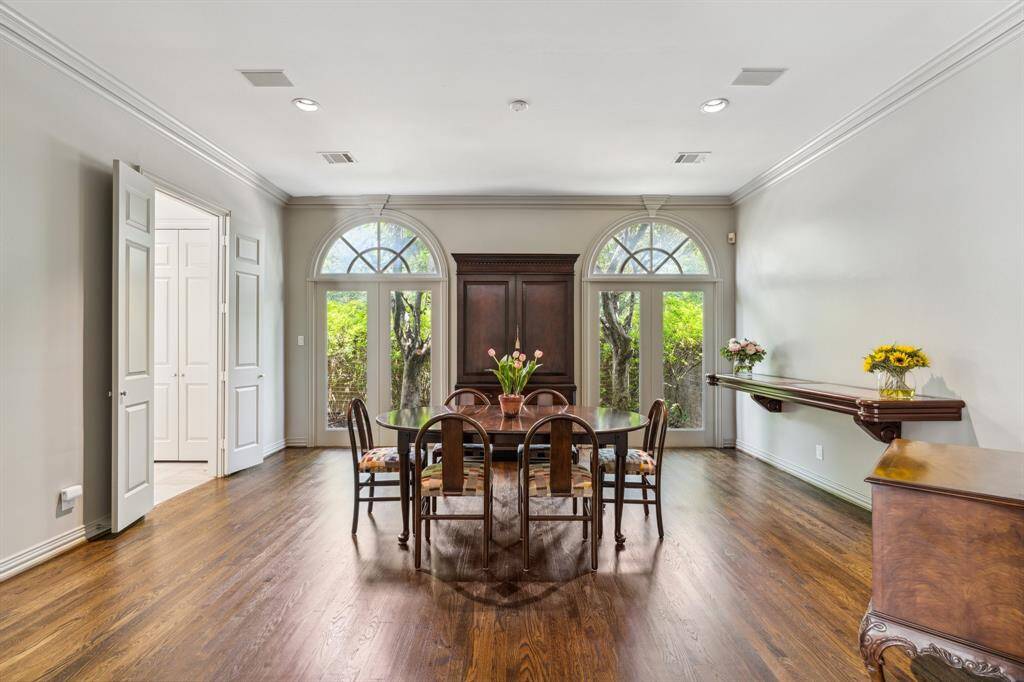 Formal Dining Room (18 x 16) is adorned with recessed lighting and classic, traditional crown molding. Note the balance and symmetry in the Palladian style fixed French doors.  There is a full house generator on the back area. The Dining Room glows with effortless charm—an elegant space that is equal parts intimate and grand. Imagine dinner parties under the soft lighting and laughter echoing off the crisp, clean walls.