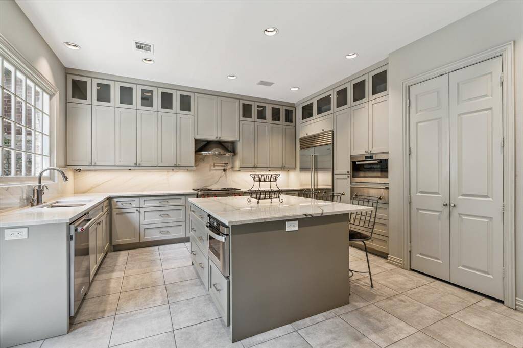 This image really lets the openness shine—this view of the Kitchen (15 x 12) shows the incredible island (with stainless steel microwave)  allowing conversations and energy to flow from homeowner to family and friends.