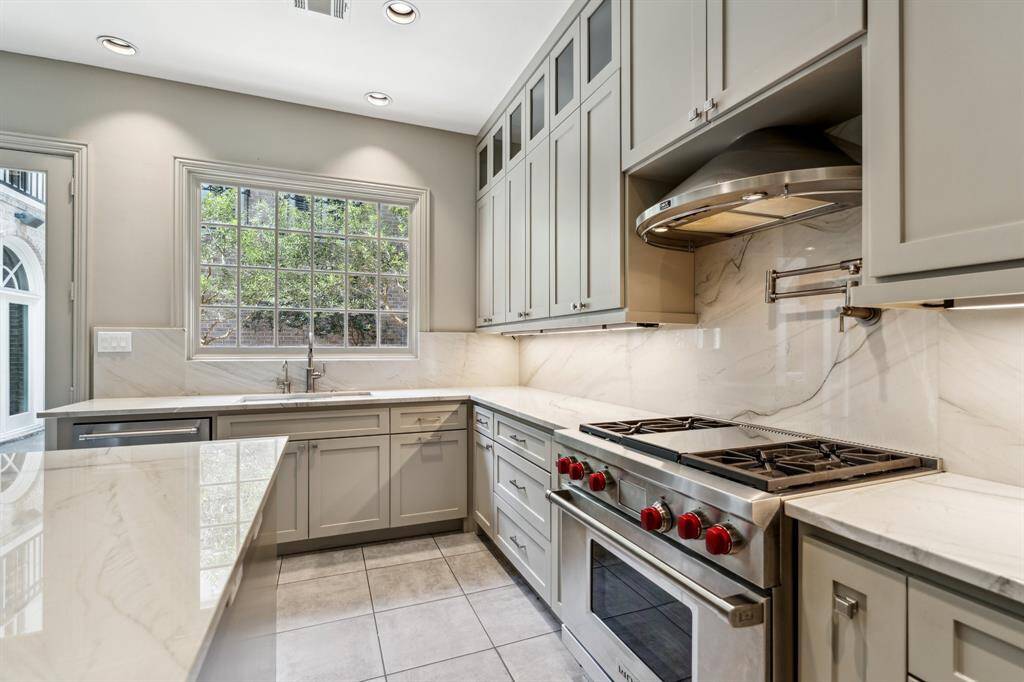 From the Wolf professional range to the custom cabinetry, this image highlights just how thoughtfully designed every inch of this kitchen was cultivated. This kitchen isn’t just functional—it’s a design-forward masterpiece with everyday flair.