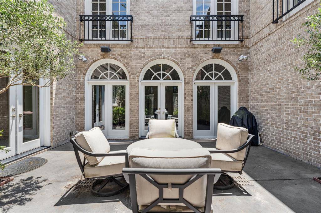 A glimpse of the interior courtyard and inviting atmosphere that the backyard patio offers. This space draws you outside, blending interior comfort with exterior tranquility and privacy.