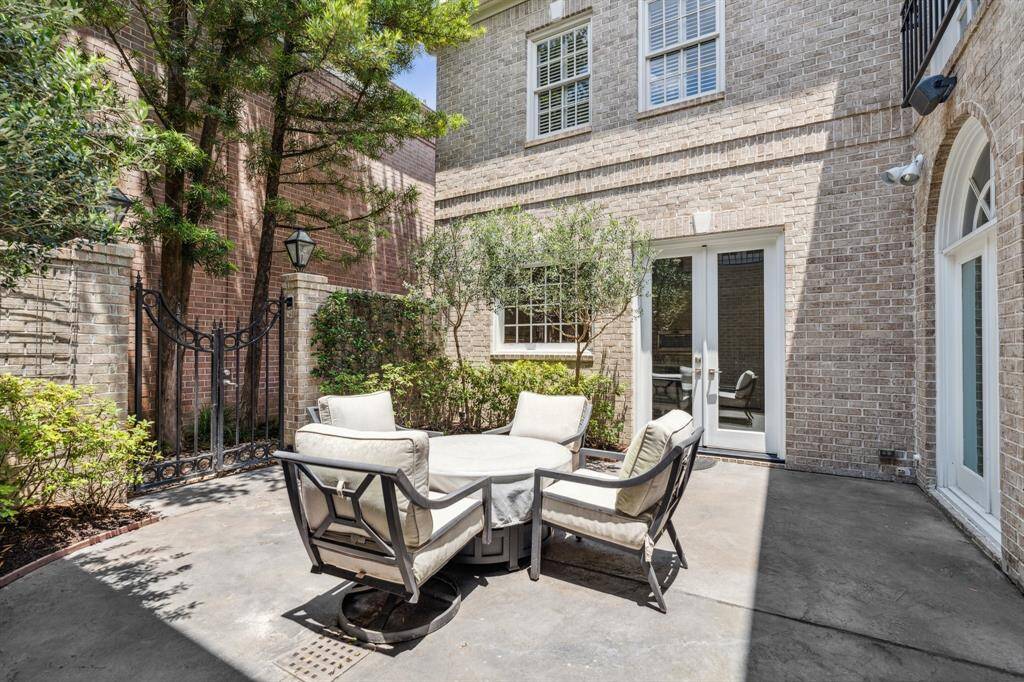 The interior courtyard is the ideal space for "al fresco" dining.  This space is accessible from the double French doors to the Kitchen as well as the double French doors to the Family Room.  The wrought iron gates allow access to the FULL HOUSE GENERATOR which could come in handy with little to no notice.