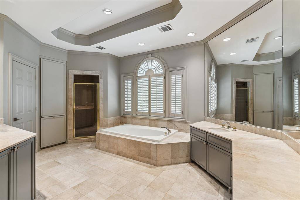 The Primary Bathroom standouts include a jetted soaking tub, private water closet, dual vanities (one with make up knee space), full length mirror and linen/laundry hamper.  Beautiful space to relax at the end of a long day.