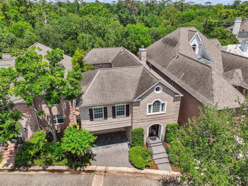 Aerial (drone) view highlighting the property. Note the carport and driveway for additional parking.