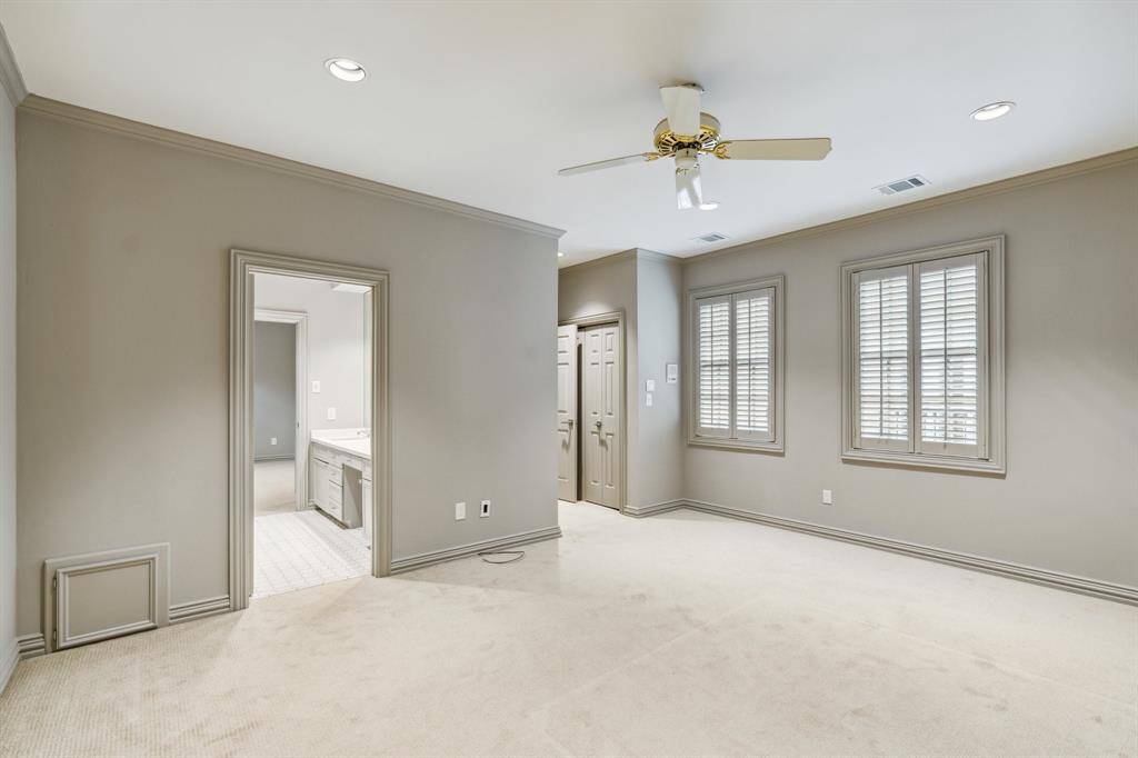 Secondary Bedroom  #3 (15 x 15) with ample closet space and large windows overlooking the courtyard patio.  Connected to Bedroom #2 through the Hollywood Bath with double vanity (2023), tub/shower and toilet area. Paint 2025.