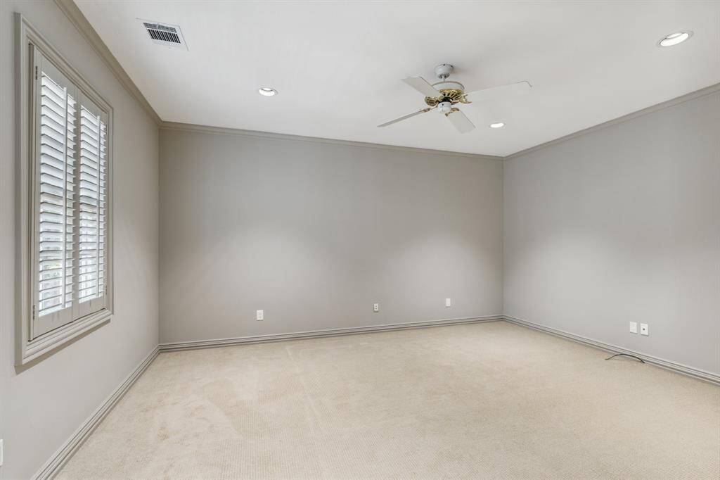 Another angle of the same bedroom reveals the layout—windows that invite the light in and plenty of wall space to personalize. It's a blank canvas full of possibilities. Paint 2025.