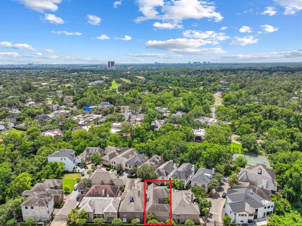 Indian Bayou is a controlled access community with 17-properties. 311 Indian Bayou is outlined in red. A dreamy street view with manicured lawns and a picture-perfect facade! This shot sets the tone—lush greenery, a pop of blooms, and curb appeal that shouts "Welcome home!" from the very first glance.