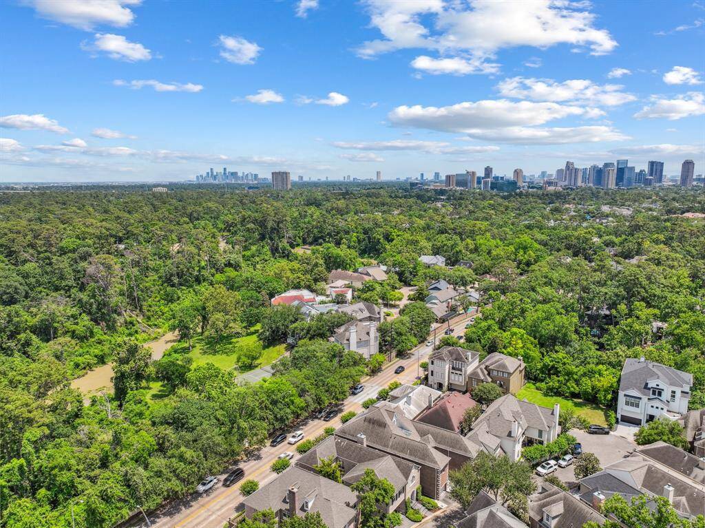 A bird’s-eye view captures the full grandeur of the property, revealing not just the house but its beautiful placement on the lot—neighboring homes, trees, and the perfect little curve of the cul-de-sac.