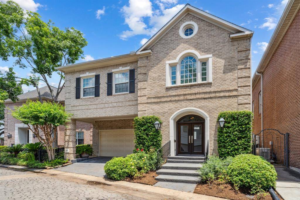 An exterior view that showcases the full width of the home—windows sparkling in the sunlight, the professional landscaping trimmed to perfection, and that front entrance just begging you to come take a closer look.