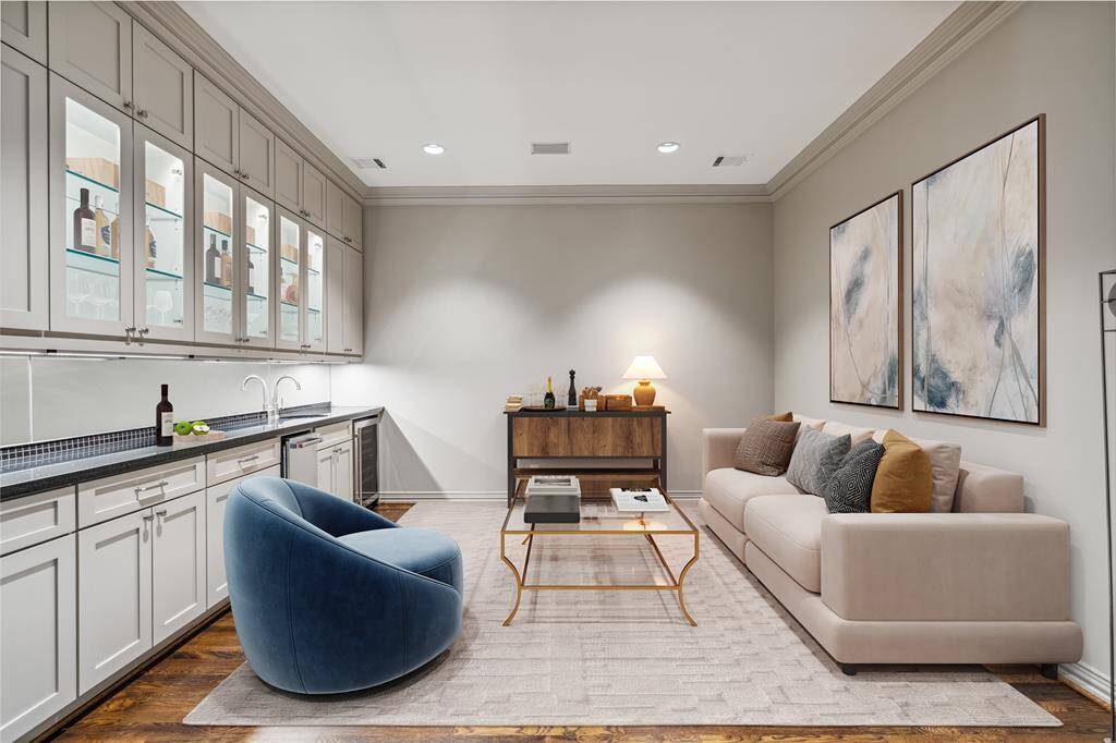 There are casual and formal living areas on both floors of this home.  The Living Room (13 x 13) is graced with gleaming oak hardwood floor, a Wet Bar with ice maker and refrigerator, granite counters with mosaic tile backsplash.  Lighted glass front upper cabinets, under cabinet lighting and cabinets to the ceiling finish out this beautiful space. This photo is virtually staged to show one possible configuration of furniture.