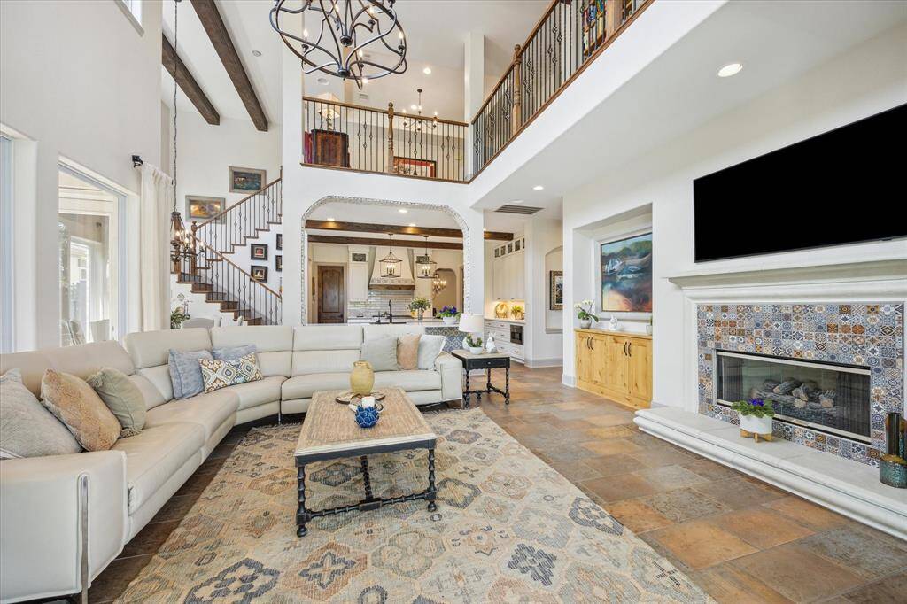 Another view of the two story family room open to the completed renovated kitchen and second staircase.