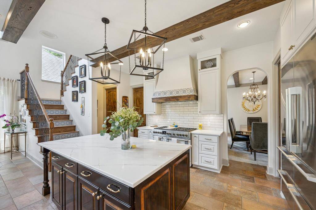 Gorgeous gourmet kitchen! Reclaimed beams, eating nook at island, custom vent hood surround! All new lighting, plumbing, appliances, backsplash, countertops and hardware!