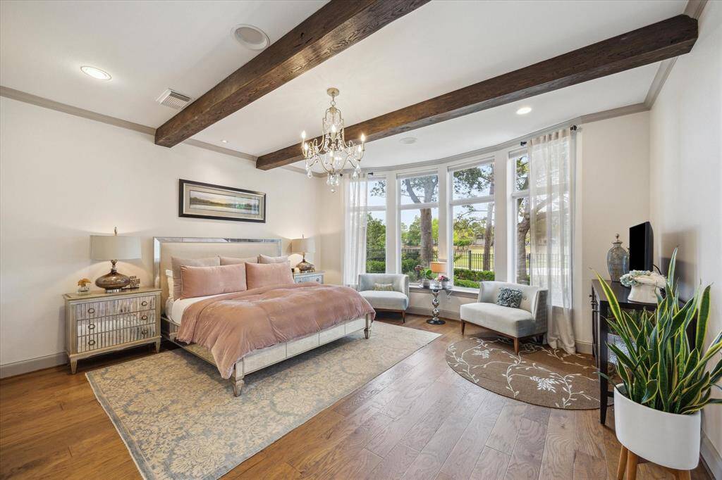 Spacious master retreat with engineered wood floors, reclaimed wood beams, beautiful sitting room with plenty of natural light a view of the golf course.