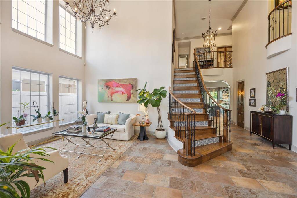 Main two story entry showcasing the formal living room, dining room and staircase with Spanish tile risers and wood treads. Entire home completely repainted inside - walls, ceilings, doors, cabinets and trim work.