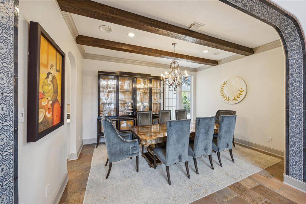 Formal dining room with reclaimed wood beams, tiled arch entry and plenty of natural light.