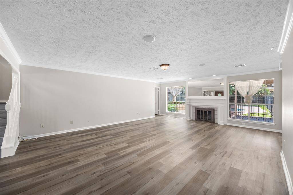 Large living room with view of the beautiful pool and back yard!